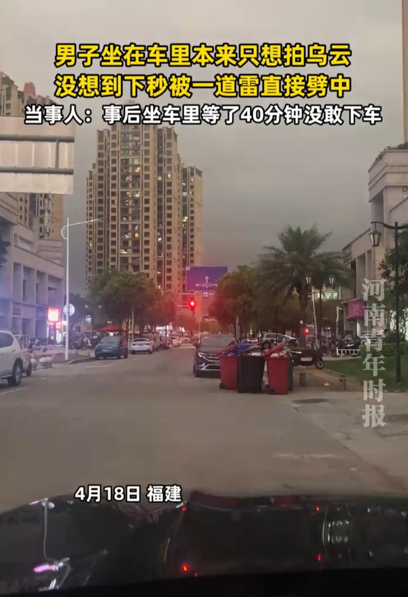 福建，一男子开车停在路边，看外面乌云打雷，就拿起手机拍视频，想着把打雷的瞬间拍下