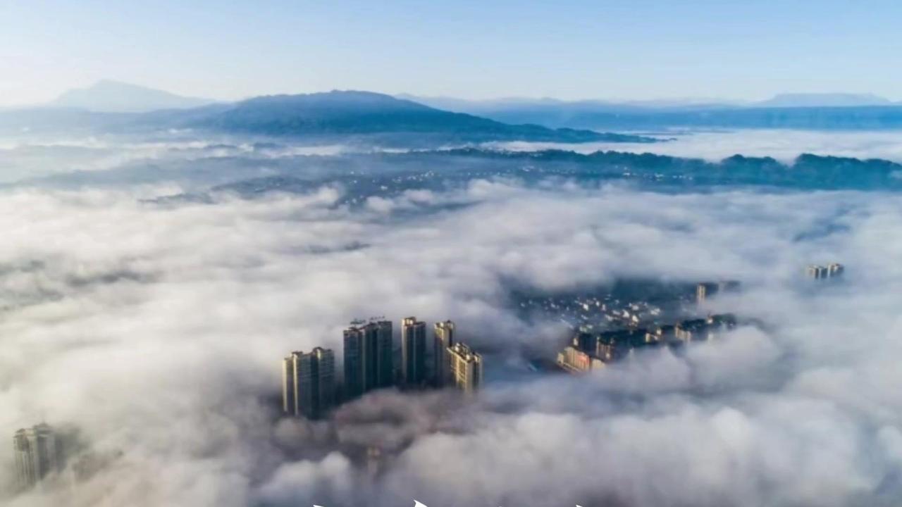 🌿从空中俯瞰洪雅，云雾缭绕的山谷像流动的绸缎，梯田层层叠叠，在阳光下泛着微光。