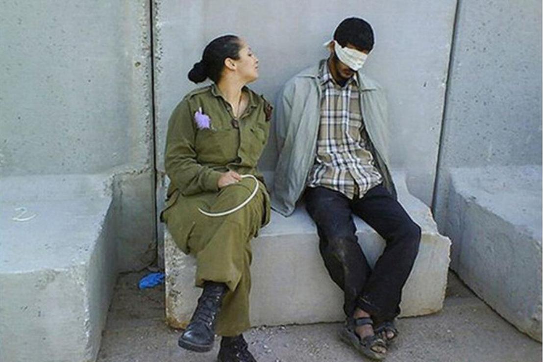 两名女兵笑着拍下退役纪念照，可她们旁边的蒙眼青年却成了最刺眼的背景，那个年轻人低