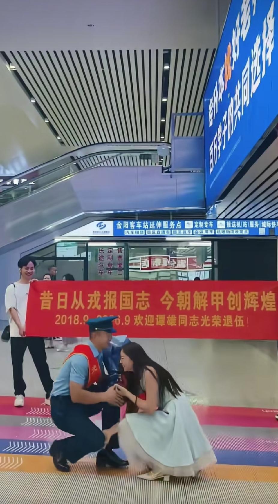 火车站出站口，一名女子突然单膝跪在一位军人面前，女子接下来的一个举动，更是让人直