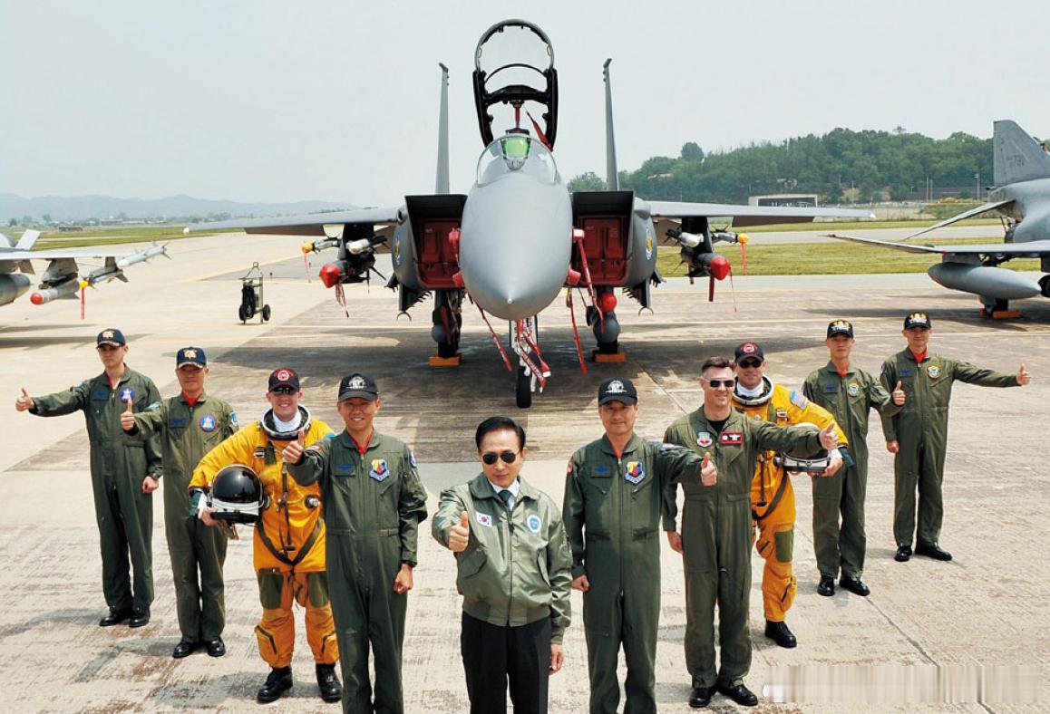 2009年6月6日韩国总统李明博（中）视察乌山空军基地，与韩美飞行员合影军事历史