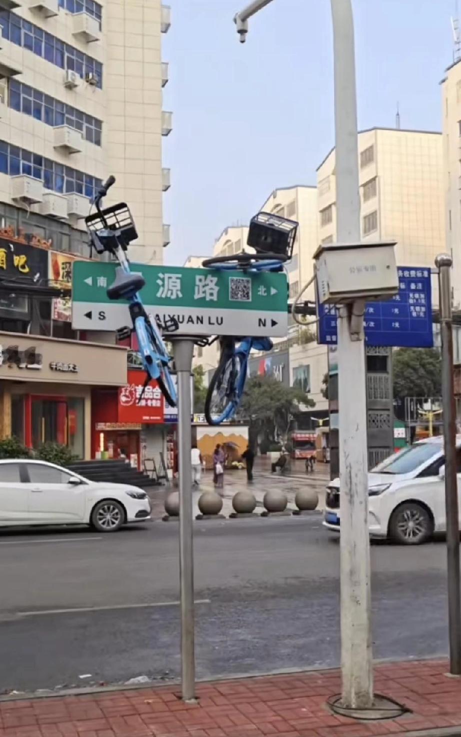 挂起来的共享单车！
这是昨天出现在开源路上的一幕，两辆哈啰共享单车，不知被何方神