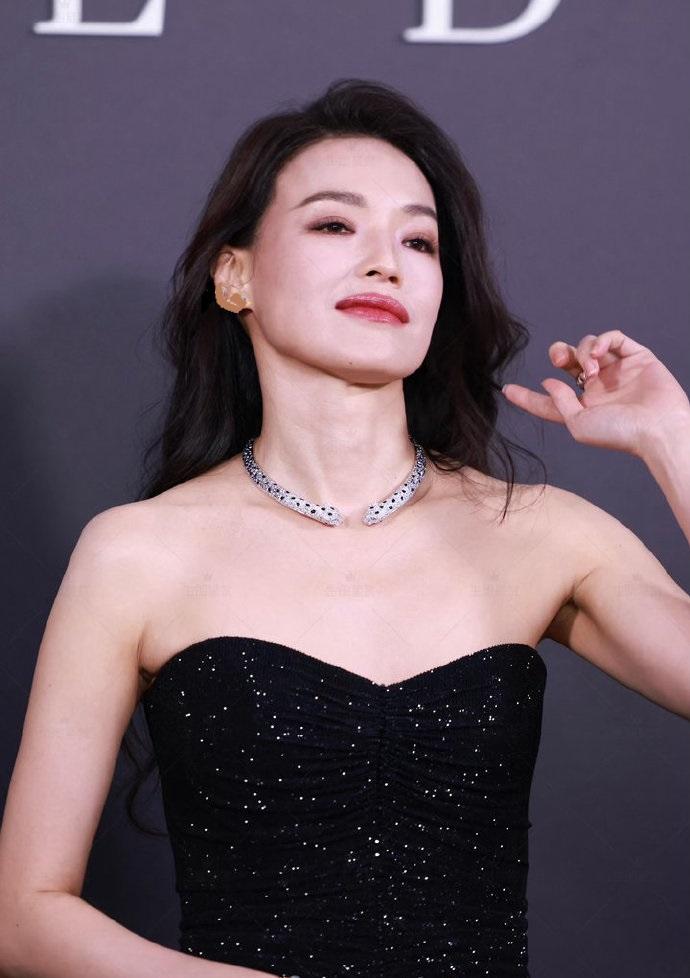 今天舒淇在出席时尚活动的时候搭配了一件紧致的黑色露肩裙，能够让她秀出完美的身材曲