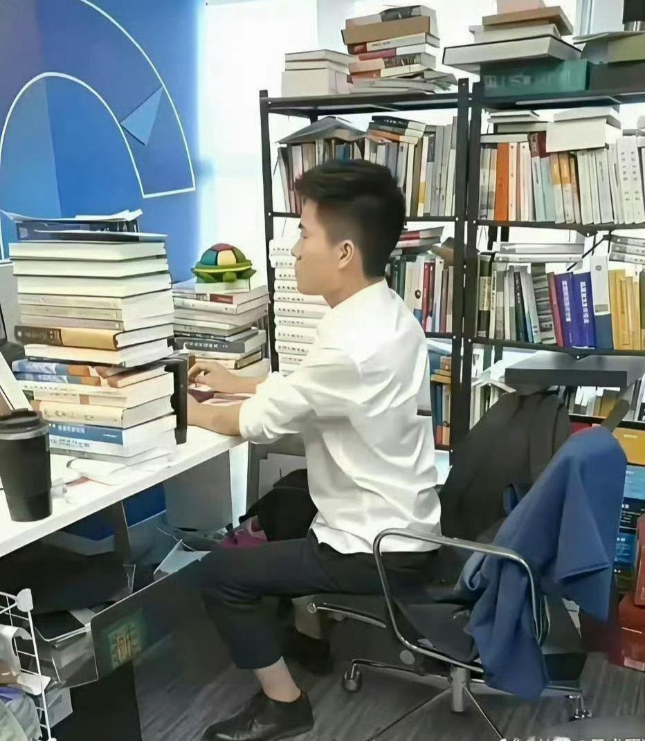 他办公的地方，是被书占领的国度。书的墙，被书环绕的四周，仿佛空气中里都漫着文字发