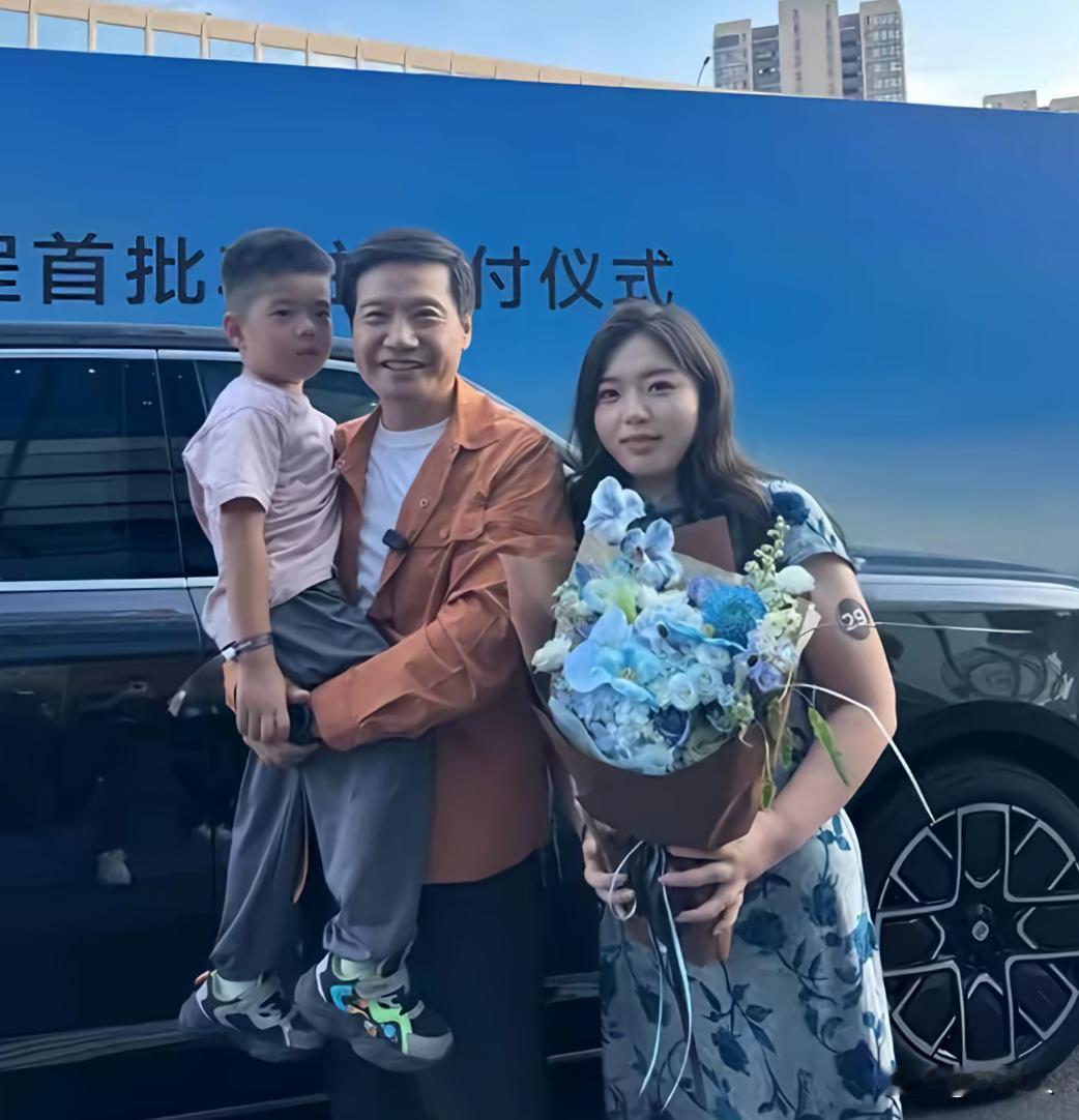 有人误以为这是雷军一家三口，其实是一位女士买小米汽车时，和雷军的一张合影。有人非