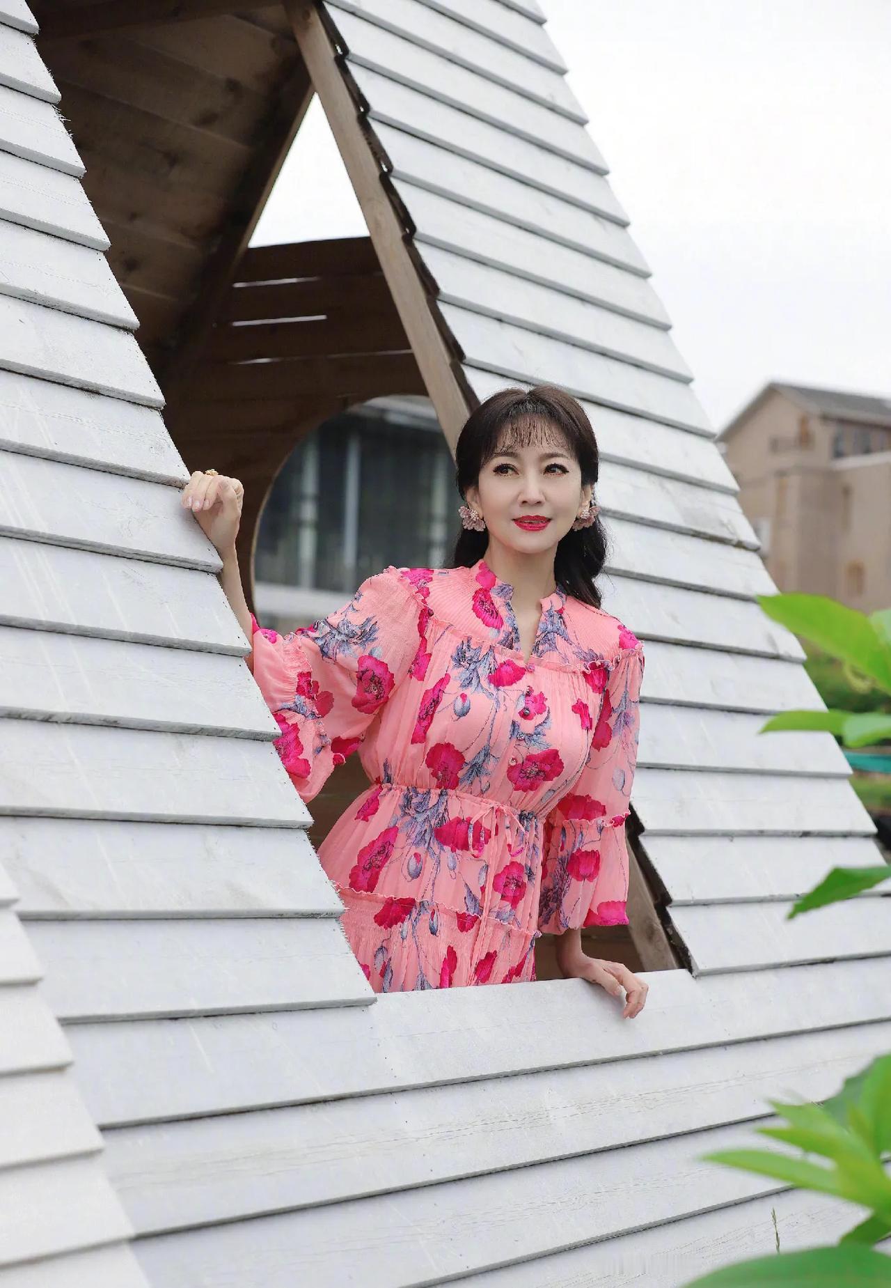 70岁赵雅芝穿红裙子拍照，和冬日告别，拥抱春日。赵雅芝在白色小屋前拍照，穿粉色碎