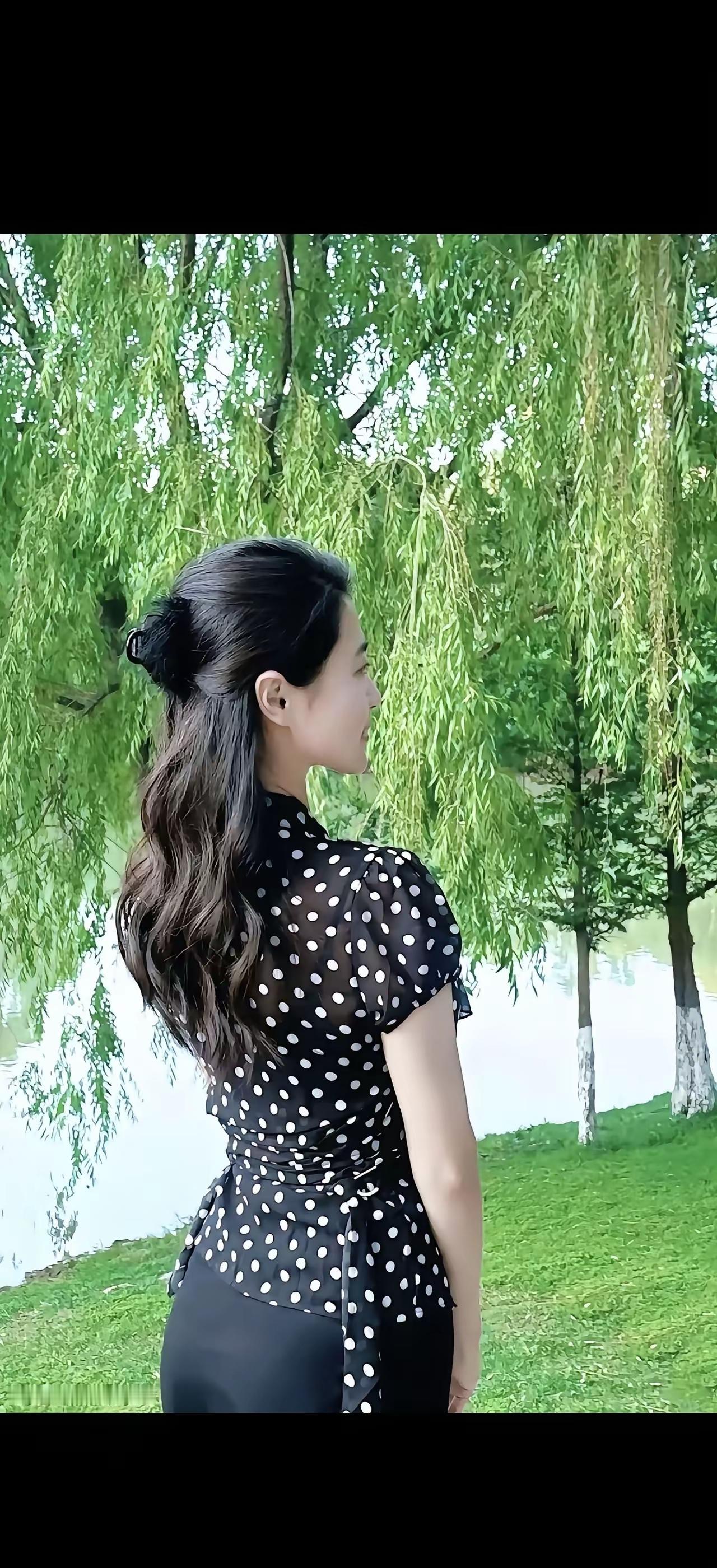 优雅黑点裙，绿意盎然中，静享自然之美。