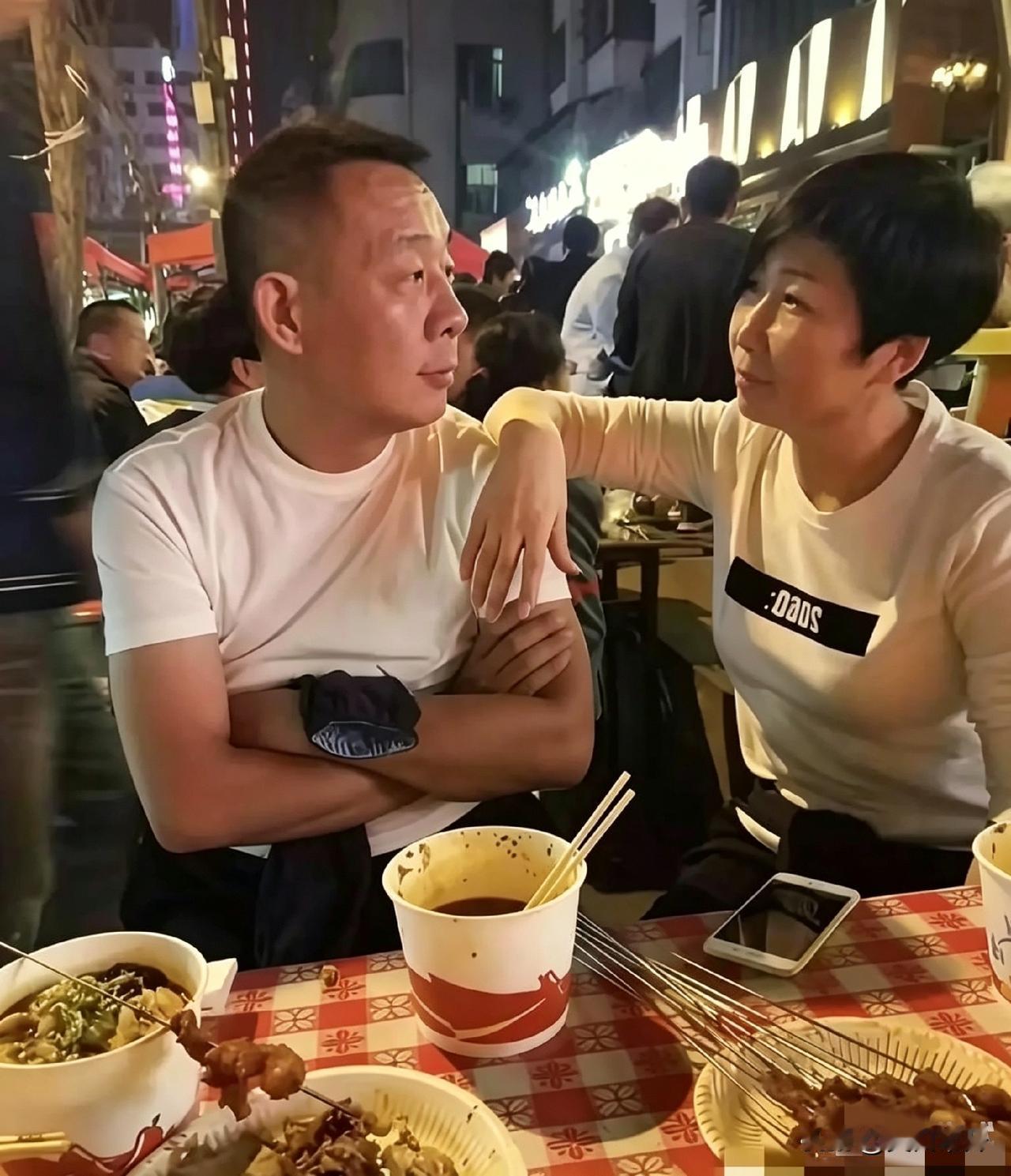 于东来拉媳妇坐街边吃大排档。两碗面，几串肉，路灯底下，烟气缭绕，周围人声嘈杂，可