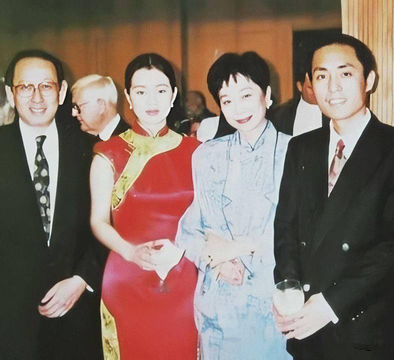 这张老照片中的张艺谋西装革履，胖瘦合度，凤表龙姿，帅爆了；身着一袭灯笼旗袍的巩俐