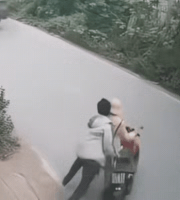 男子将坐在摩托车上的女子一把推向了驶来的大货车，大货车紧急制动加上男子的力量不足