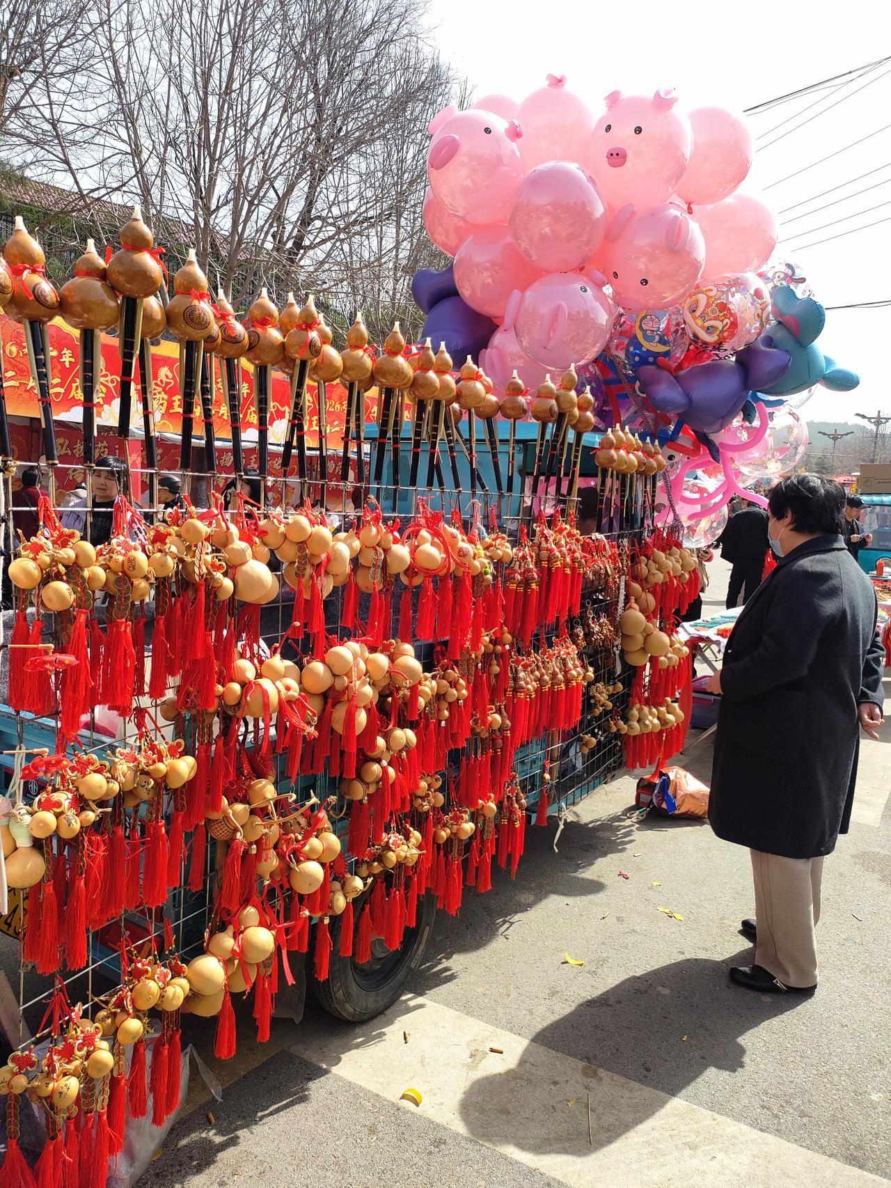 集市的热闹裹着年味儿，
每一件小物件都在说：
日子要过得热热闹闹，才不负这好春光