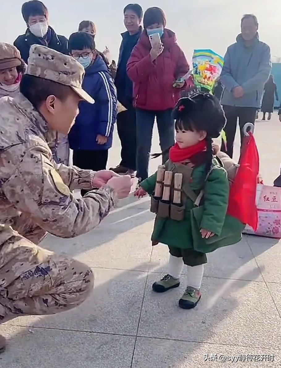 竟然被一个穿军装的小萌娃，感动到了！视频中的她，只有三四岁的样子。头戴五角星的棉