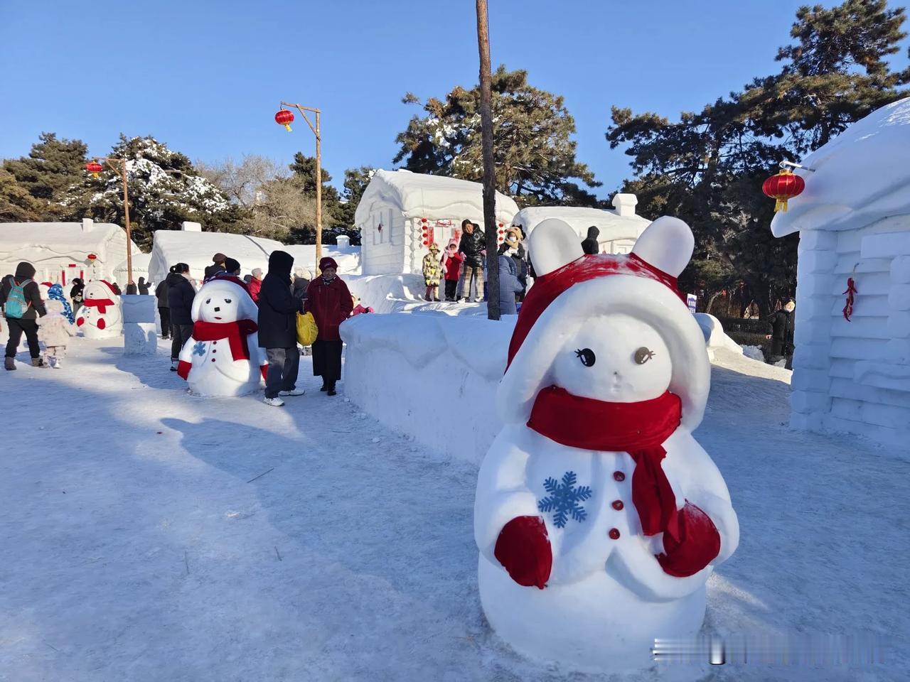 最近，长春南湖公园挺火，这里的村落雪雕挺好玩，雪宝宝戴红帽子、扎红围脖，形象真是