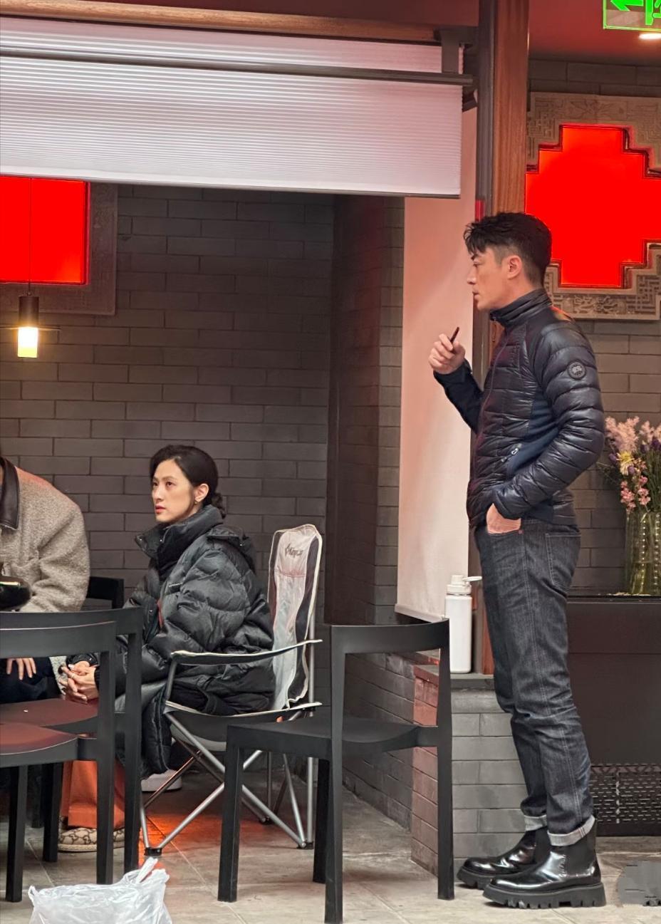 霍建华现身北京餐馆，深蓝色紧身轻薄羽绒服，黑色牛仔裤，短款马靴，身材挺拔，五官棱