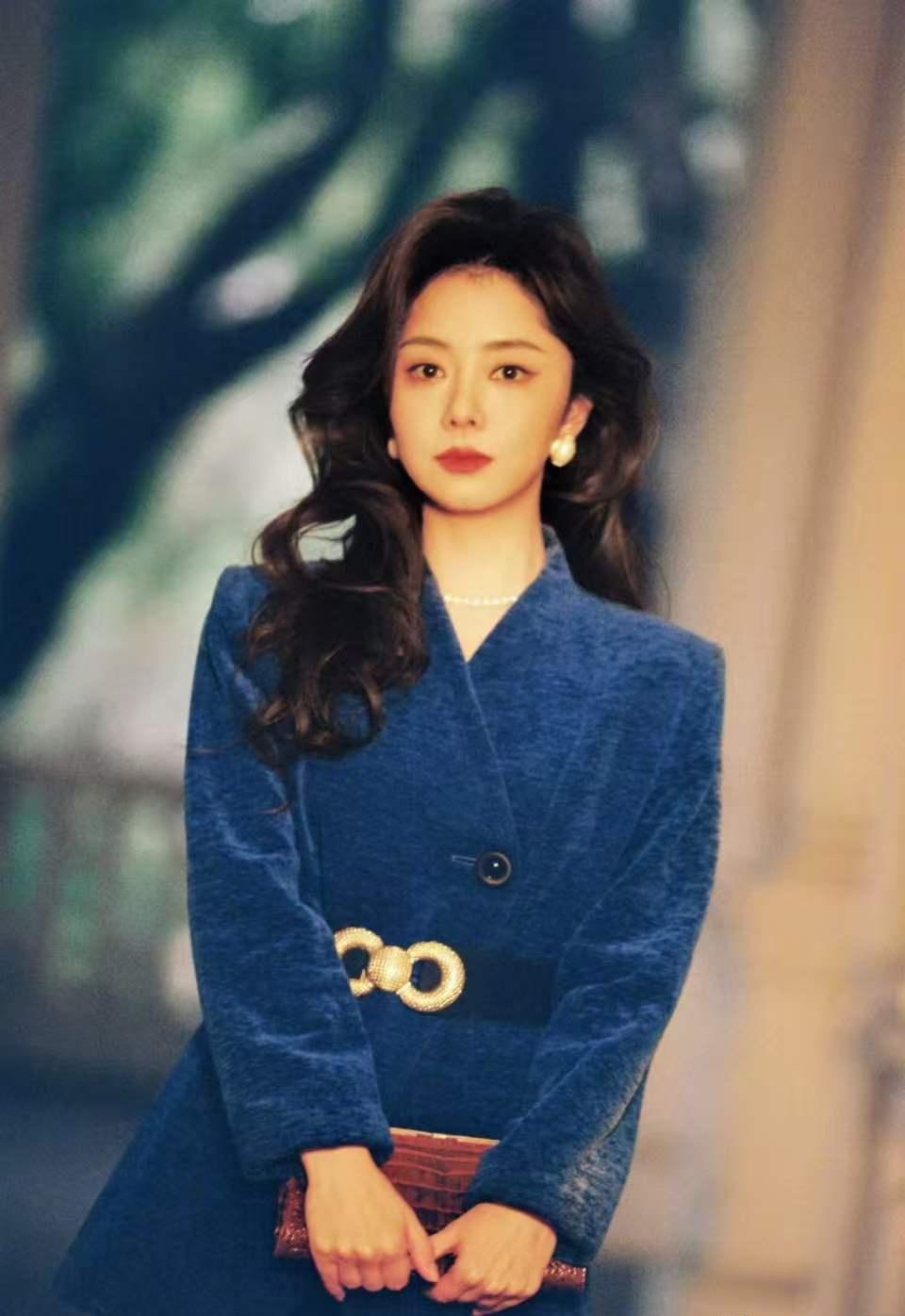大波浪卷发散着慵懒港风，宝蓝色灯芯绒西装衬得肤色透亮，珍珠配饰点缀出温柔质感，每
