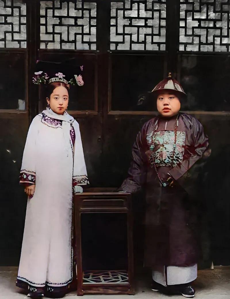 清末，一个年轻的官员和他夫人的合影。

看样子，这个脑满肠肥的小伙级别还不低，估