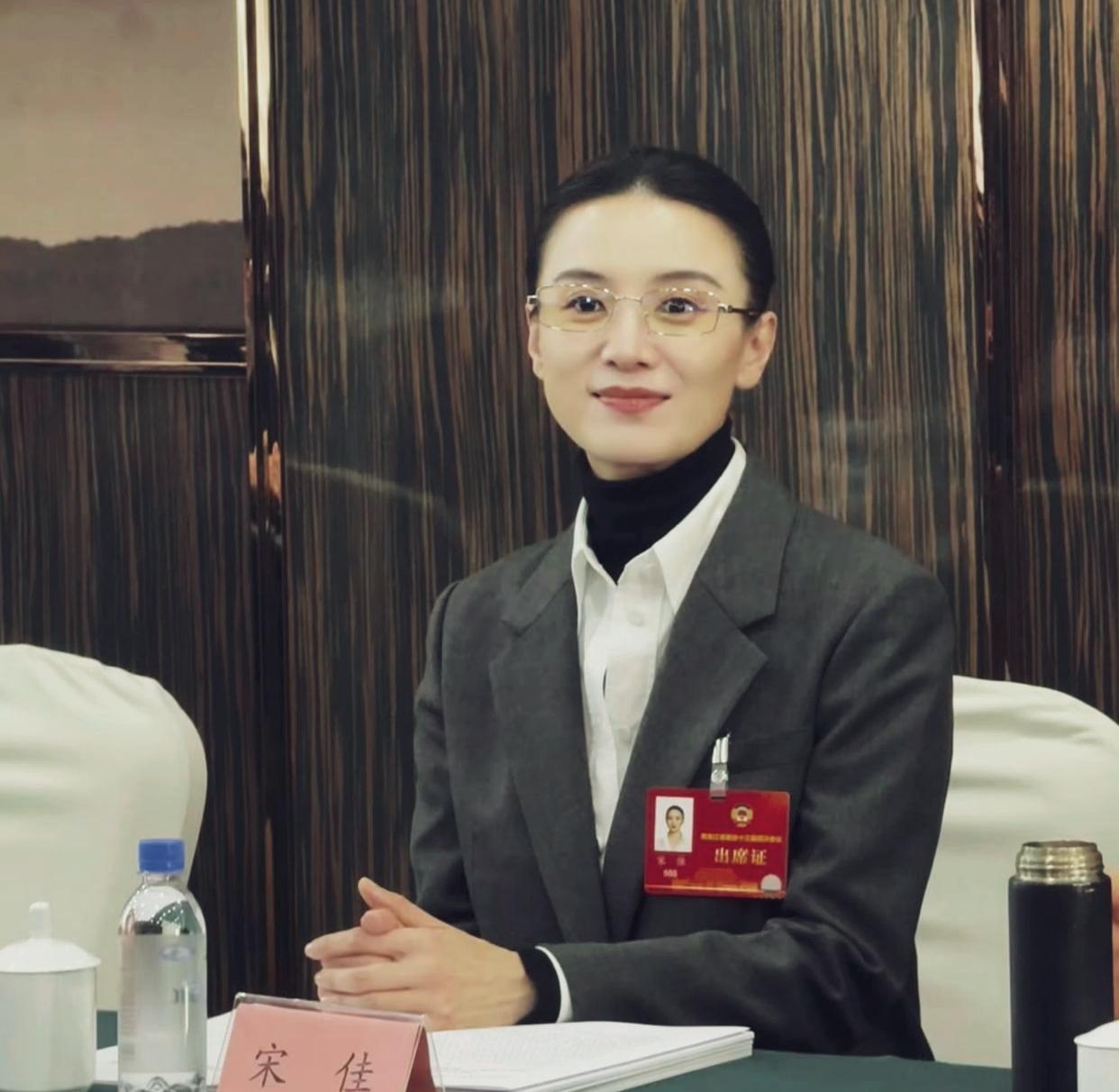 宋佳身着灰色西装套装，搭配金丝边眼镜，盘发造型利落干练，优雅气质，堪称体制内穿搭