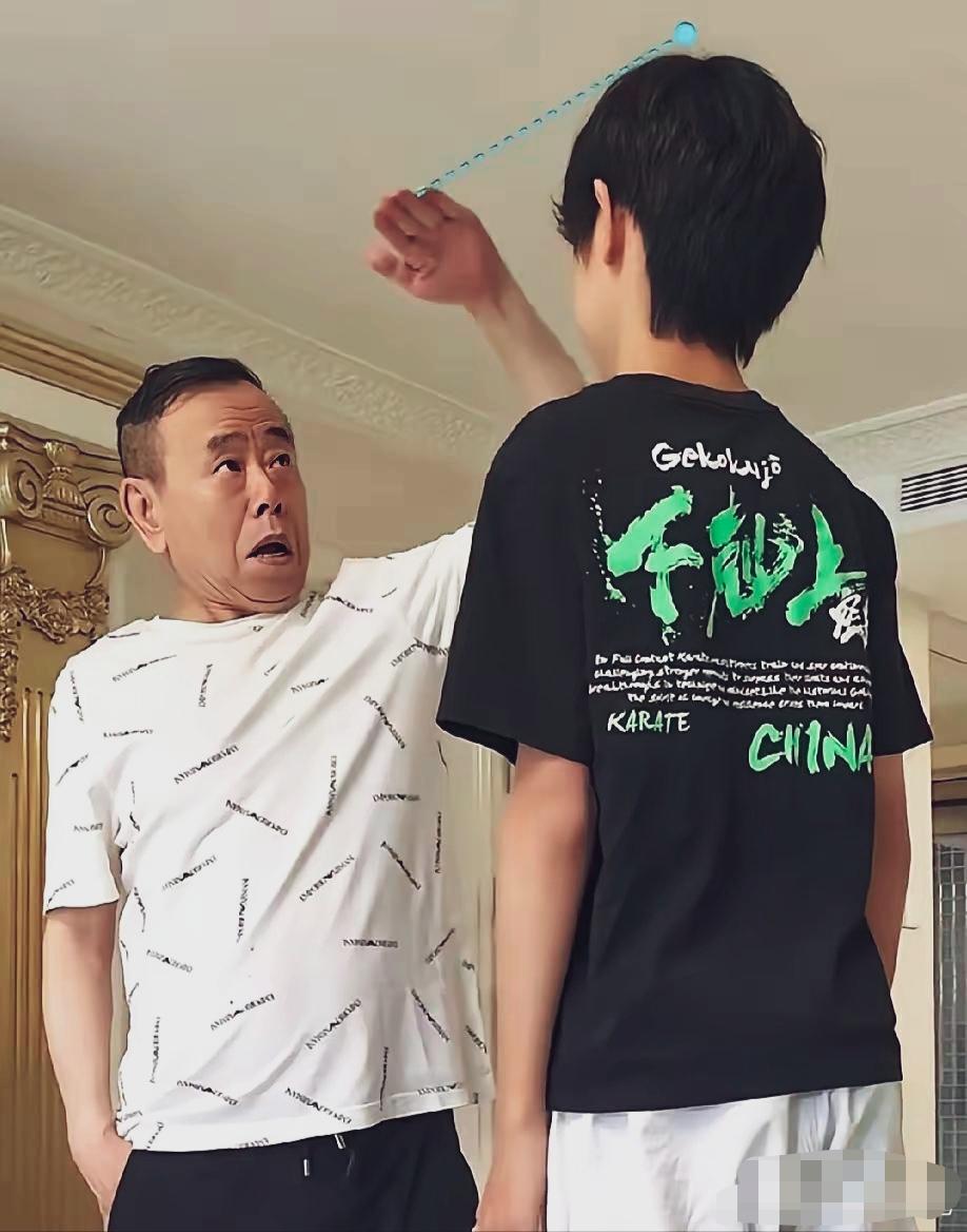 潘长江正在测量自己外孙的身高；潘长江露出惊讶的神情，因为外孙年纪不大，身高已经远