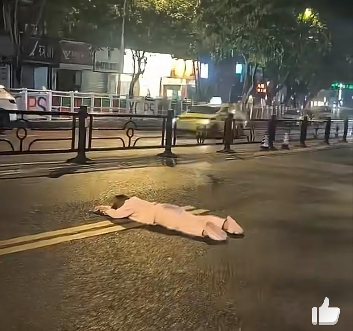 这个穿睡衣的女孩怎么了，大晚上的在马路上横爬，受了啥刺激，这个动作太危险了。有啥