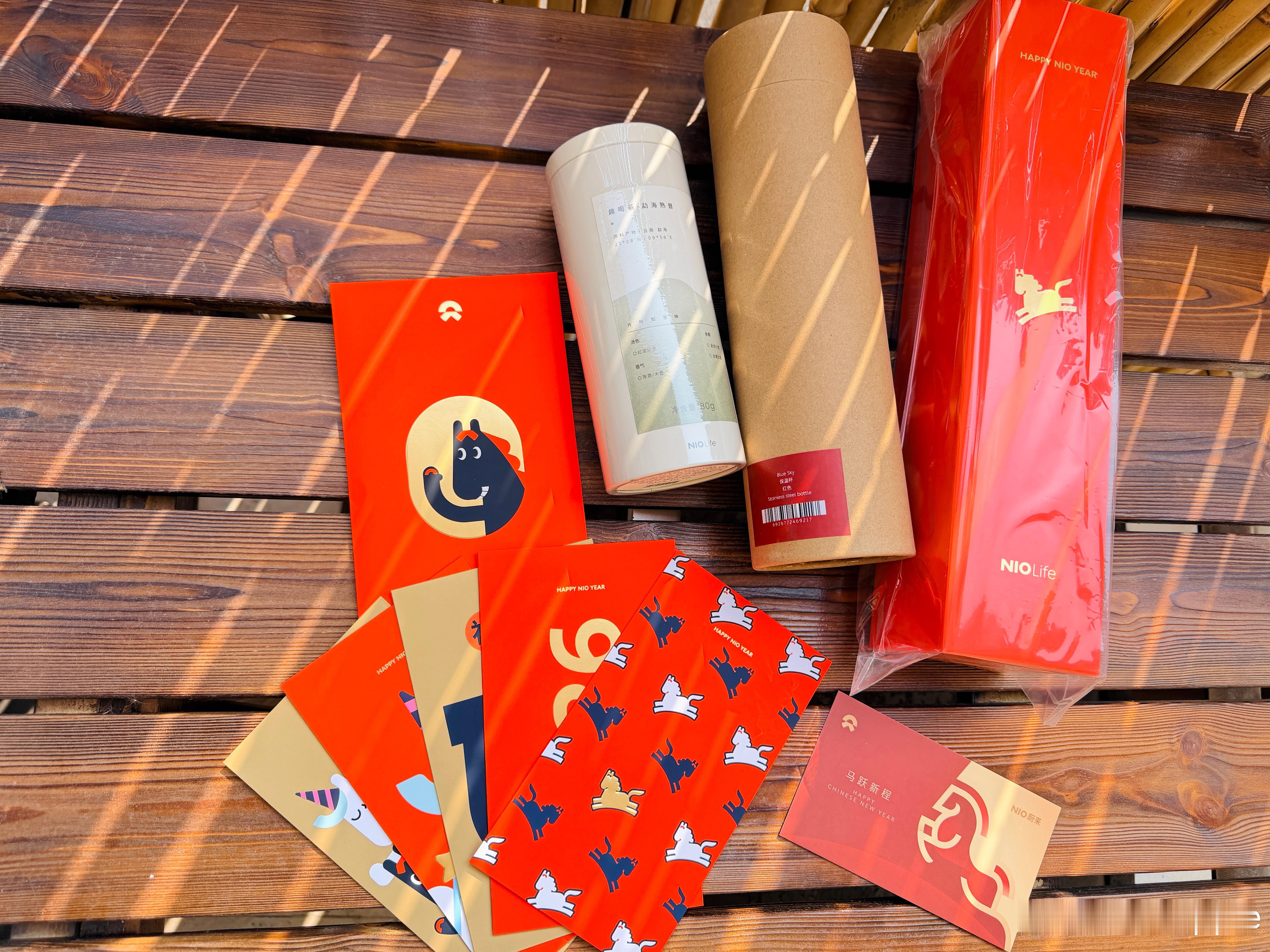 收到蔚来的新年🎁啦  年味十足有红包封、手写春联、红色保温杯还有我超爱喝的普洱