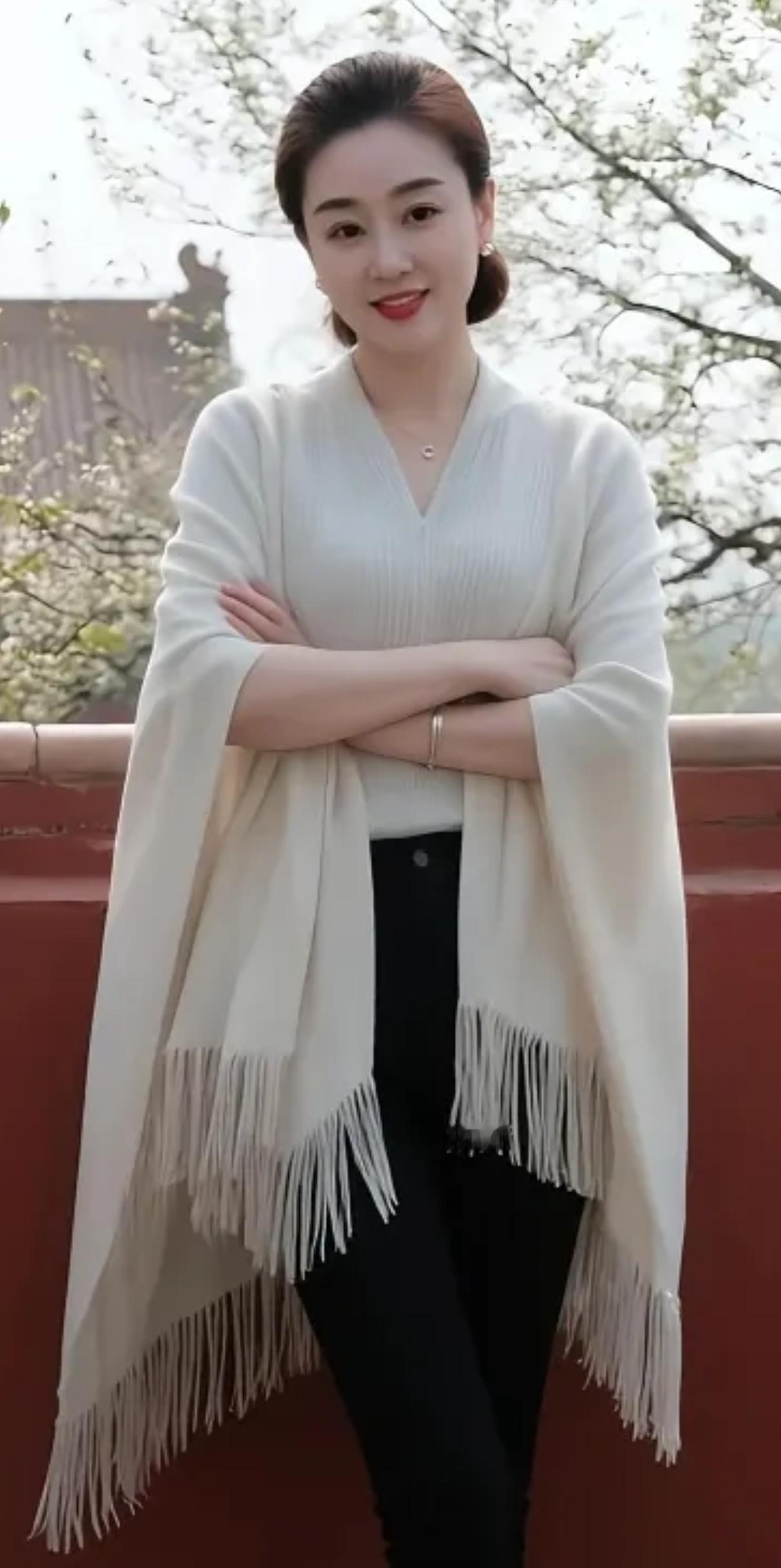 优雅气质，温柔如春日暖阳，米色披肩搭配黑色裤装，尽显时尚与优雅。
米色针织外套 