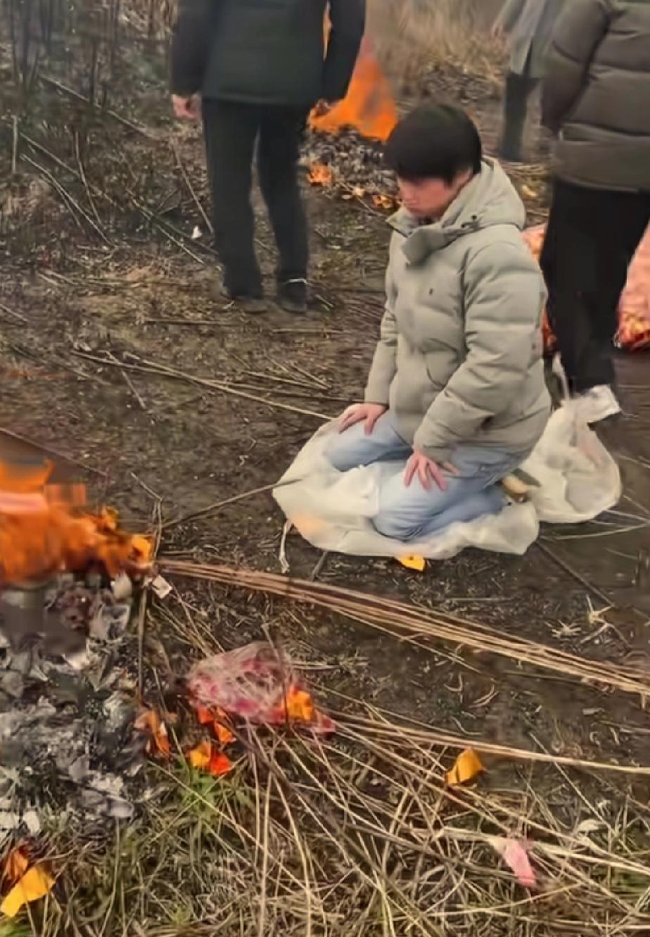 高洋跪在父亲坟前，久久不愿起来，1994年，高洋和父母在成都火车站失散后，长期寻