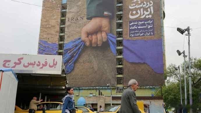 美国对伊朗进行海上封锁后，德黑兰市中心挂起巨型广告牌，牌子上写着：霍尔木兹海峡永