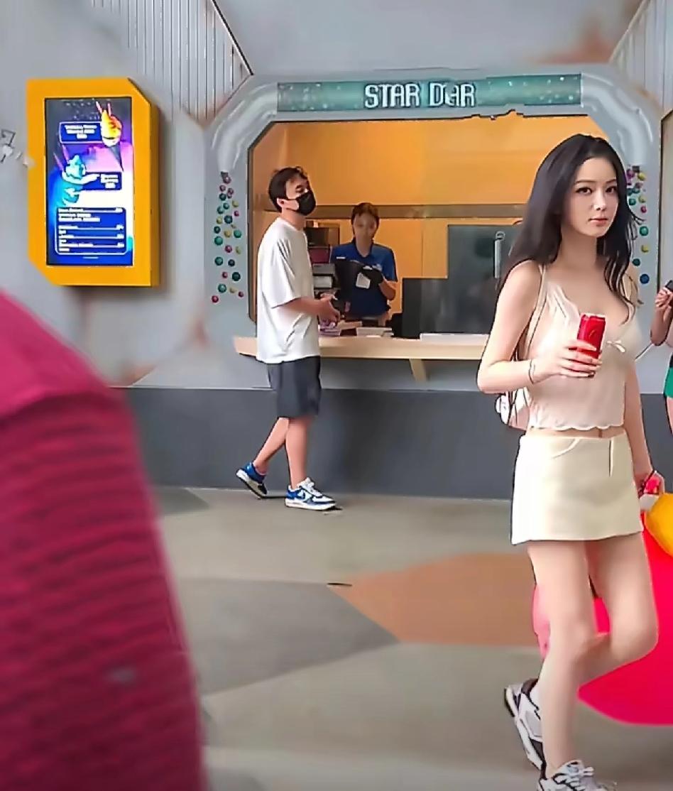 王思聪低调现身新加坡，身着简约白T恤与灰色短裤，脚穿平价耐克鞋，展现朴素一面。