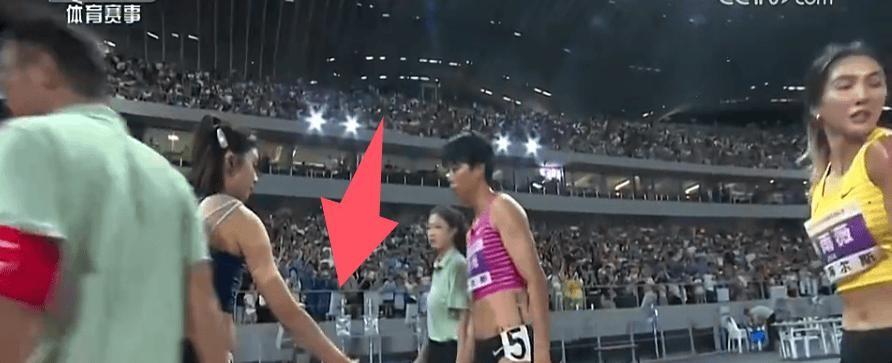 8月4日全国田径锦标赛女子100米栏决赛结束时，吴艳妮攥着号码布站在跑道边，13