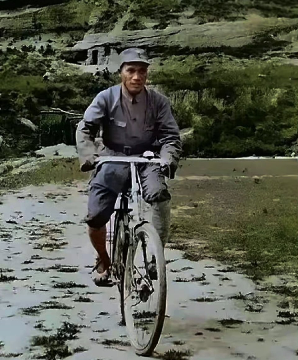 1938年，延安的马路上朱老总骑着自行车从前线赶回来开会时的一幕，正好被摄影师拍