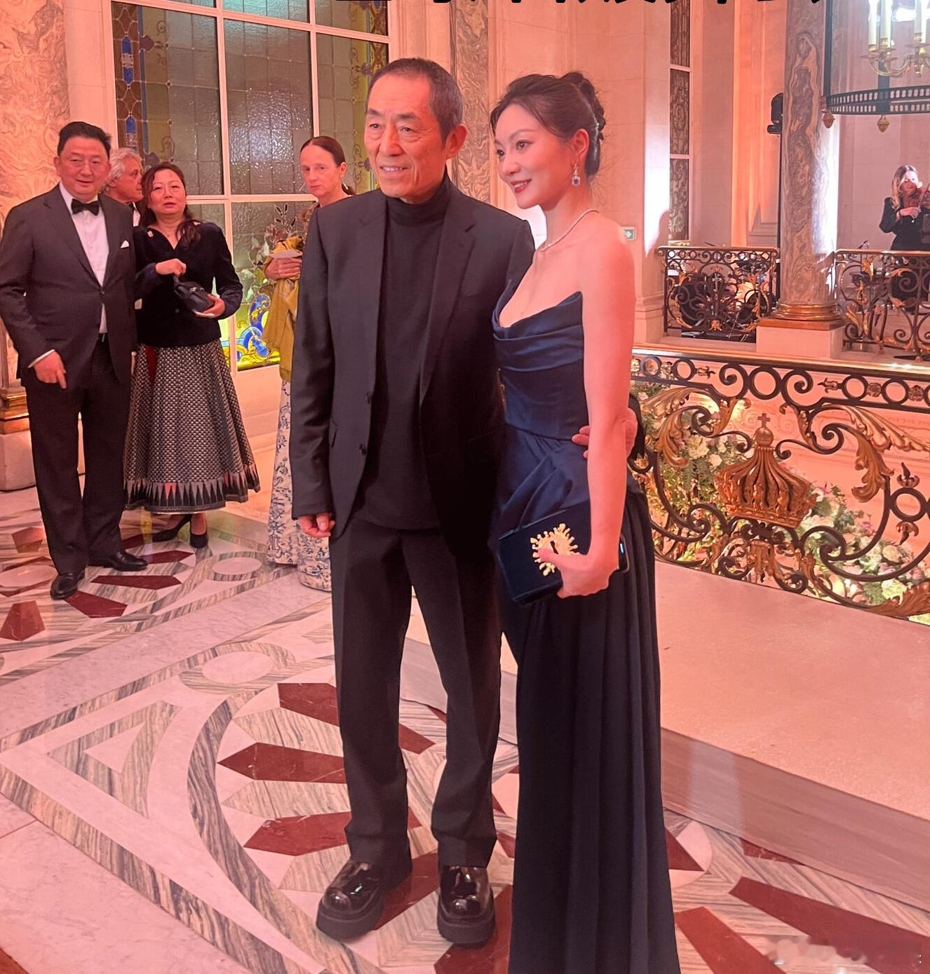 张艺谋一家参加巴黎名媛舞会  张艺谋蹲着给妻子拍照 张艺谋带妻子儿女参加巴黎名媛