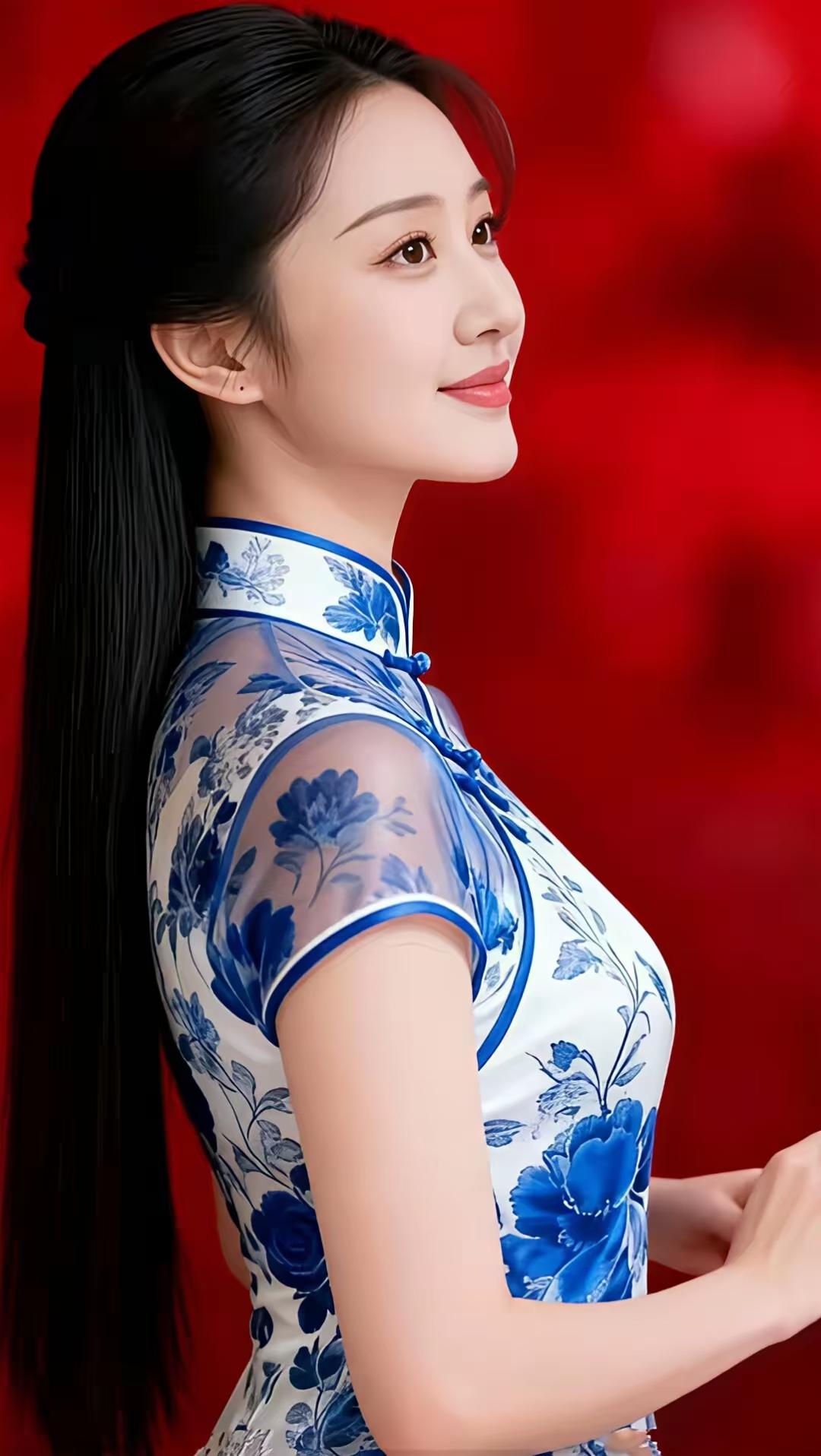 水仙子·青花旗袍影
素缎裁就染青花，
薄纱映臂透绮霞。
青丝垂缕云容画，
丹颜含