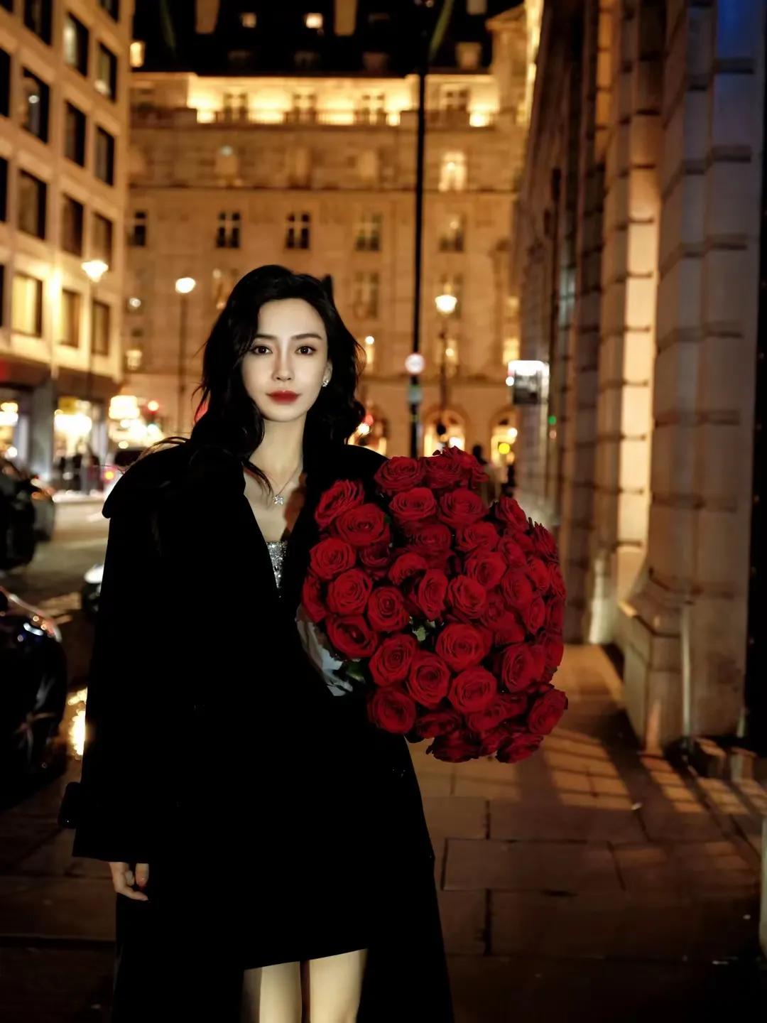 杨颖夜色街头与红玫瑰的浪漫邂逅

夜色街头，杨颖手捧红玫瑰，如梦似幻。娇艳玫瑰与