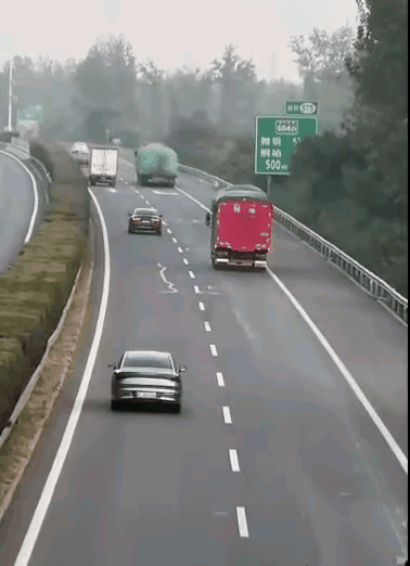这样超车是不是太冒险了？一辆灰色小车不顾自身安全，在两辆货车左右之间，快速度超过