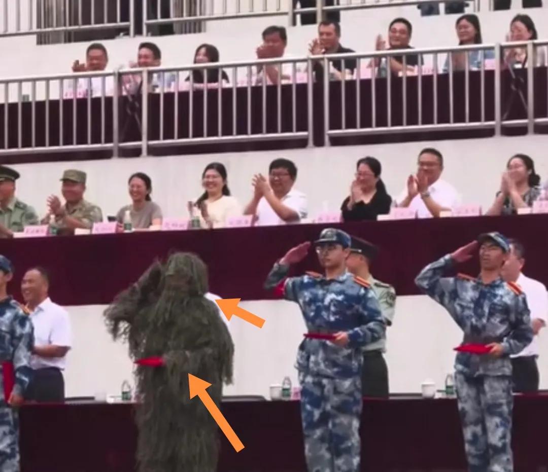 一士兵穿“吉利服”上台领奖敬礼。