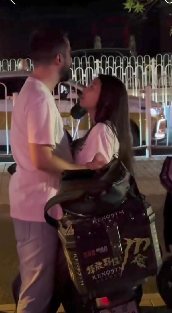 她真开放。
一骑电动车女子在公交上落站偶遇两老外，两老外轮流和她相拥。
虽然有其