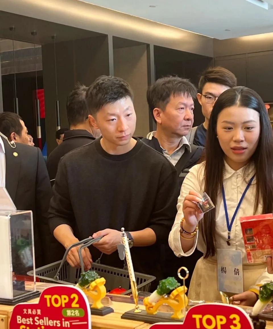 马龙买完纪念品排队结账。[祝福]
故宫博物院活动结束，龙队挑选了许多纪念品，笑容