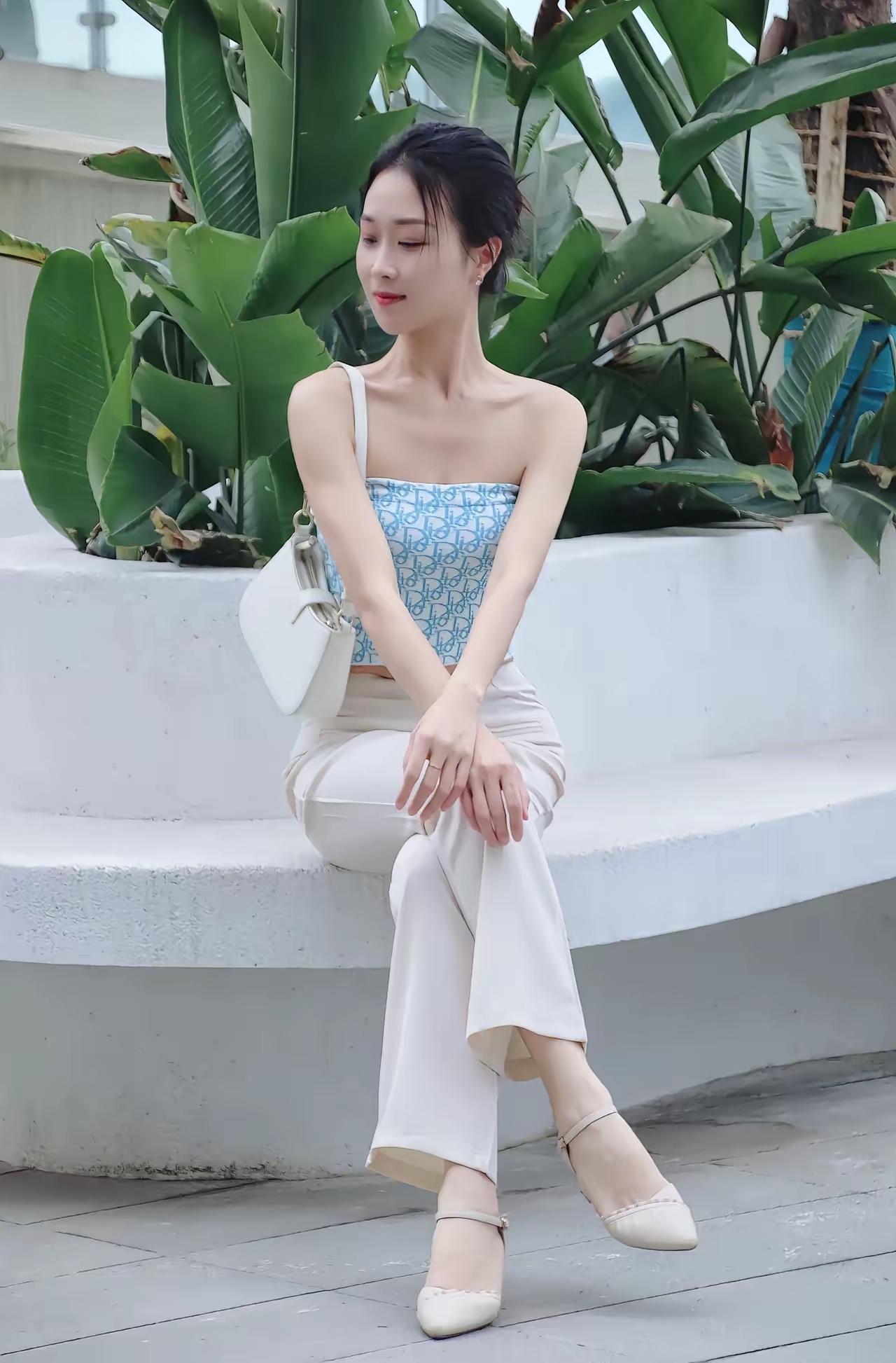 夏日清新穿搭，白色裤装搭配蓝白印花吊带，优雅坐于绿植旁。白色衬衫裙穿搭 白衬衫白