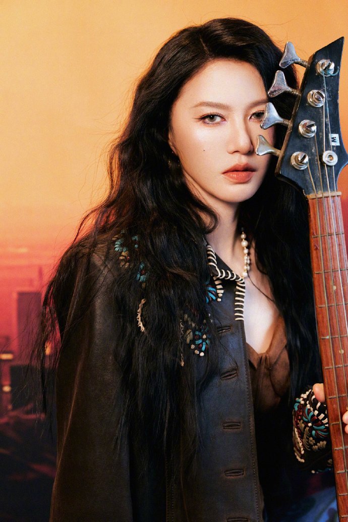 谭维维美拉德造型 长款风衣的卡其色被风掀起一角，露出里面焦糖色的针织裙，行走间像