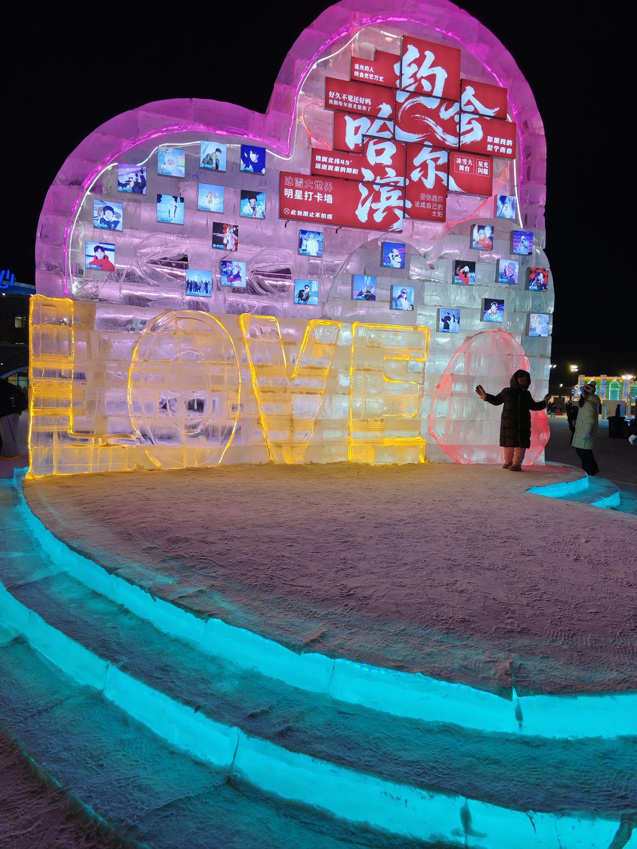 镜头下哈尔滨漫步冰雪大世界，偶遇这面爱心冰墙。冰砖里嵌着的照片满是笑意，脚下的冰