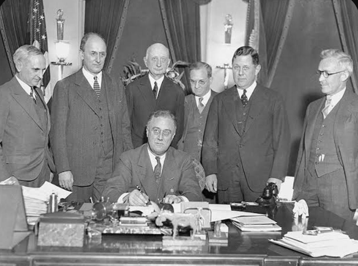 这张照片是1933年4月5日美国总统罗斯福签署著名的第6102号行政令时的场景。