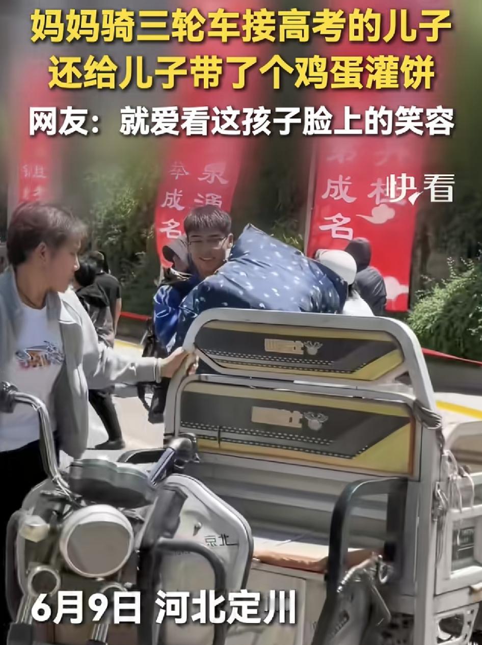 高考结束，河北定州一位母亲骑着三轮车接孩子回家，孩子提着大包小包的行李。看到母亲