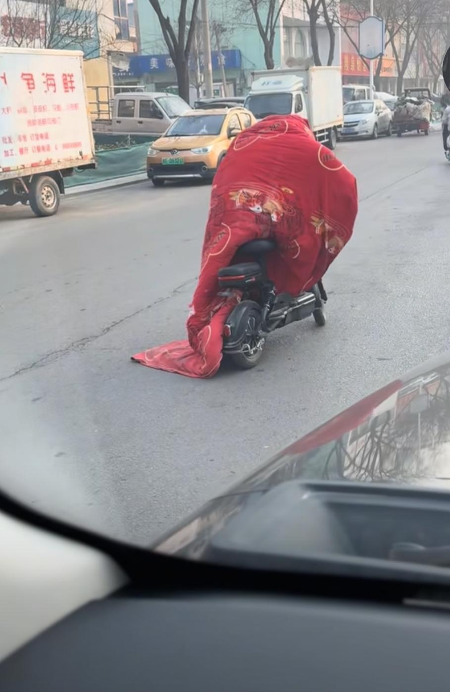 这天气是有多冷啊！这大哥做了许多人想做却不敢做的事情，看起来挺滑稽的。
    