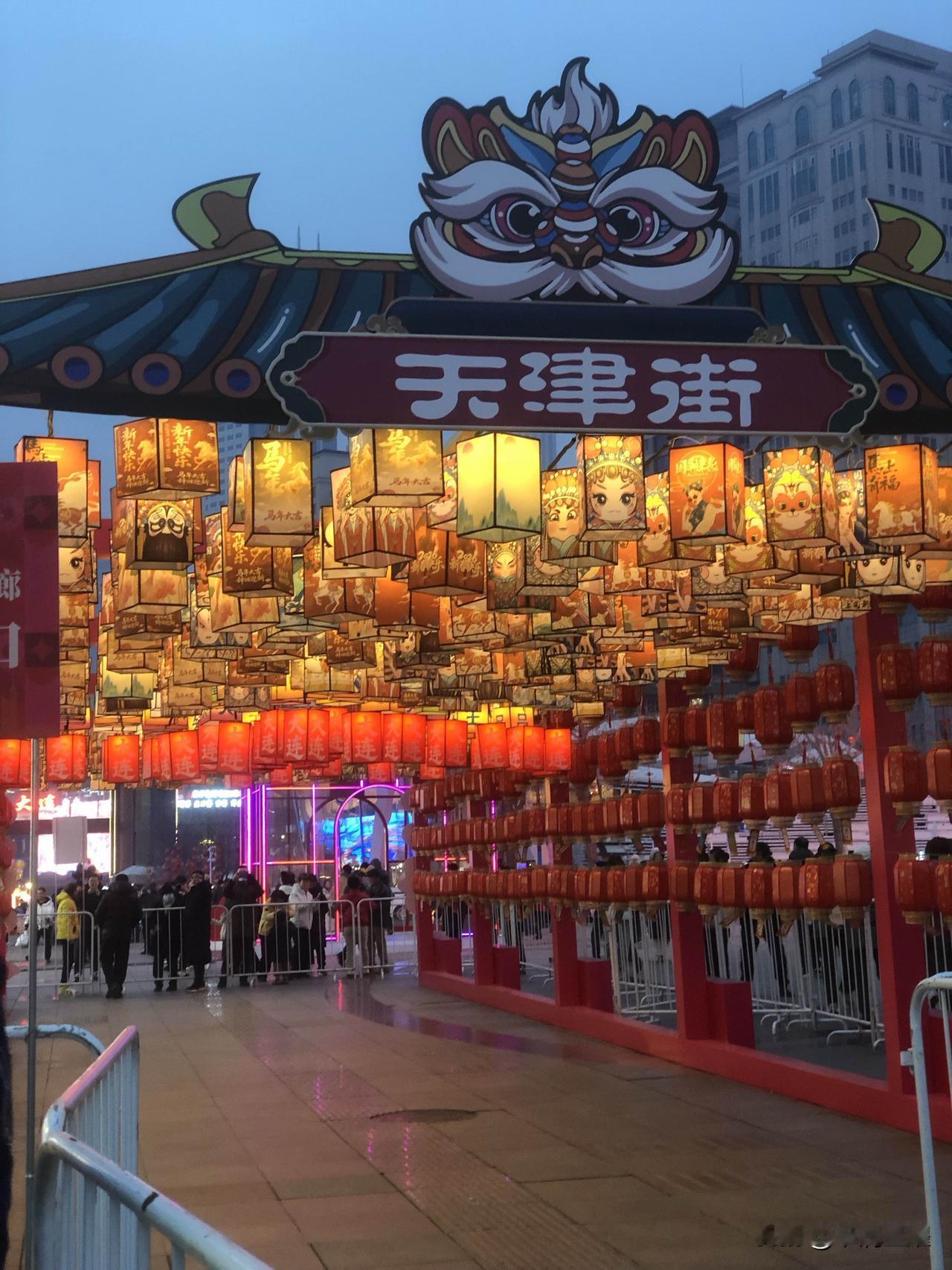 大连天津街举办的元宵节活动，从排队等待汤圆、猜灯谜、到马蹄石广场的节目，人们的参