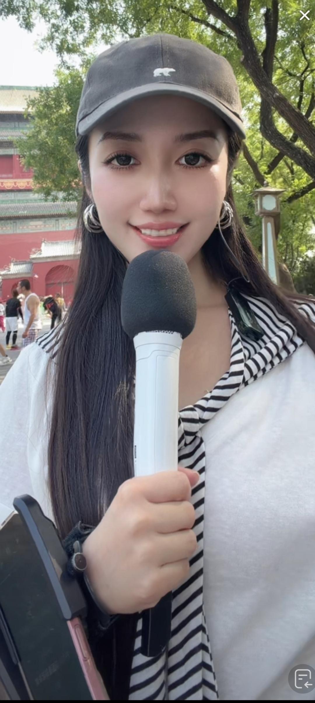 这位小姐姐在户外采访呢。