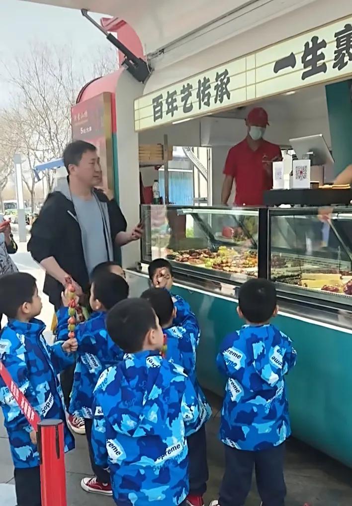 这段视频真的越看越有味道！7个孩子穿着同款衣服、拿着糖葫芦的样子，既可爱又让人忍