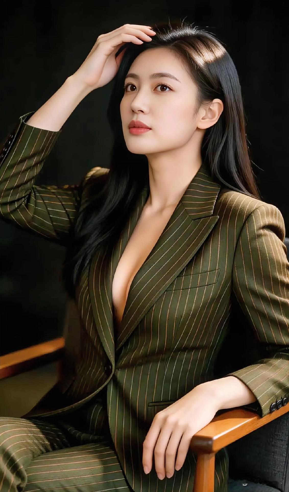 墨绿条纹西装，黑发垂肩，轻扶发梢显优雅。