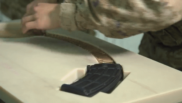 我们部队使用的新式子弹快装器，把散装的子弹摆好，直接一推，就能填满一个弹匣，非常