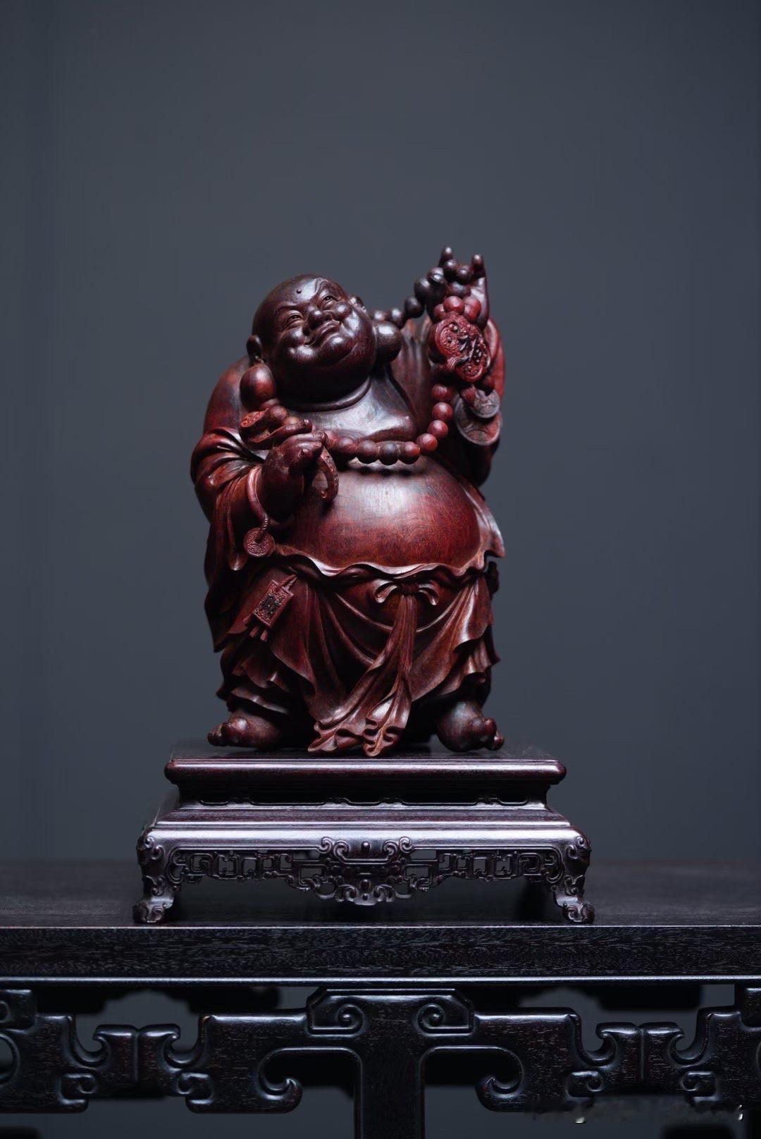 这尊弥勒，不是第一眼的“精”，
而是越看越有味道的“松”。

紫檀的底色沉稳温润