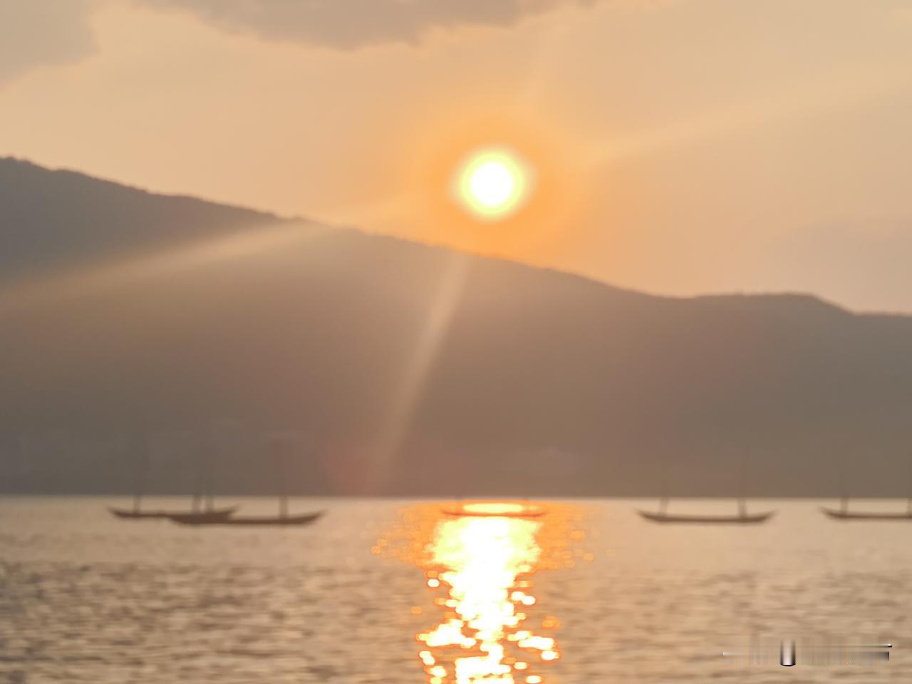 发张你手机里最美的夕阳照可以吗落日衔山，金辉漫过滇池水面。粼粼波光里，几叶渔舟静
